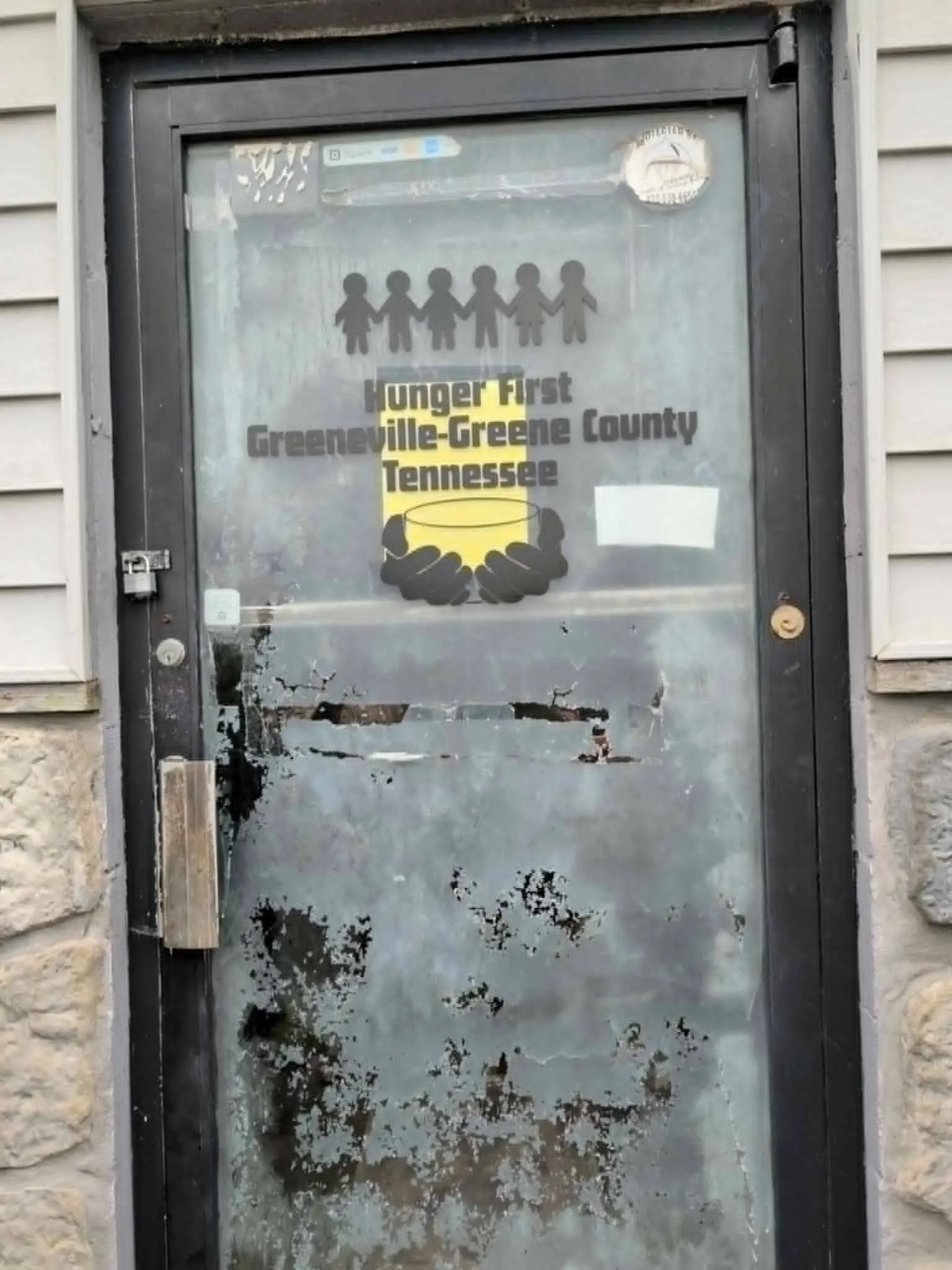 The front door at Hunger First Greeneville with the organization’s decal on the glass.