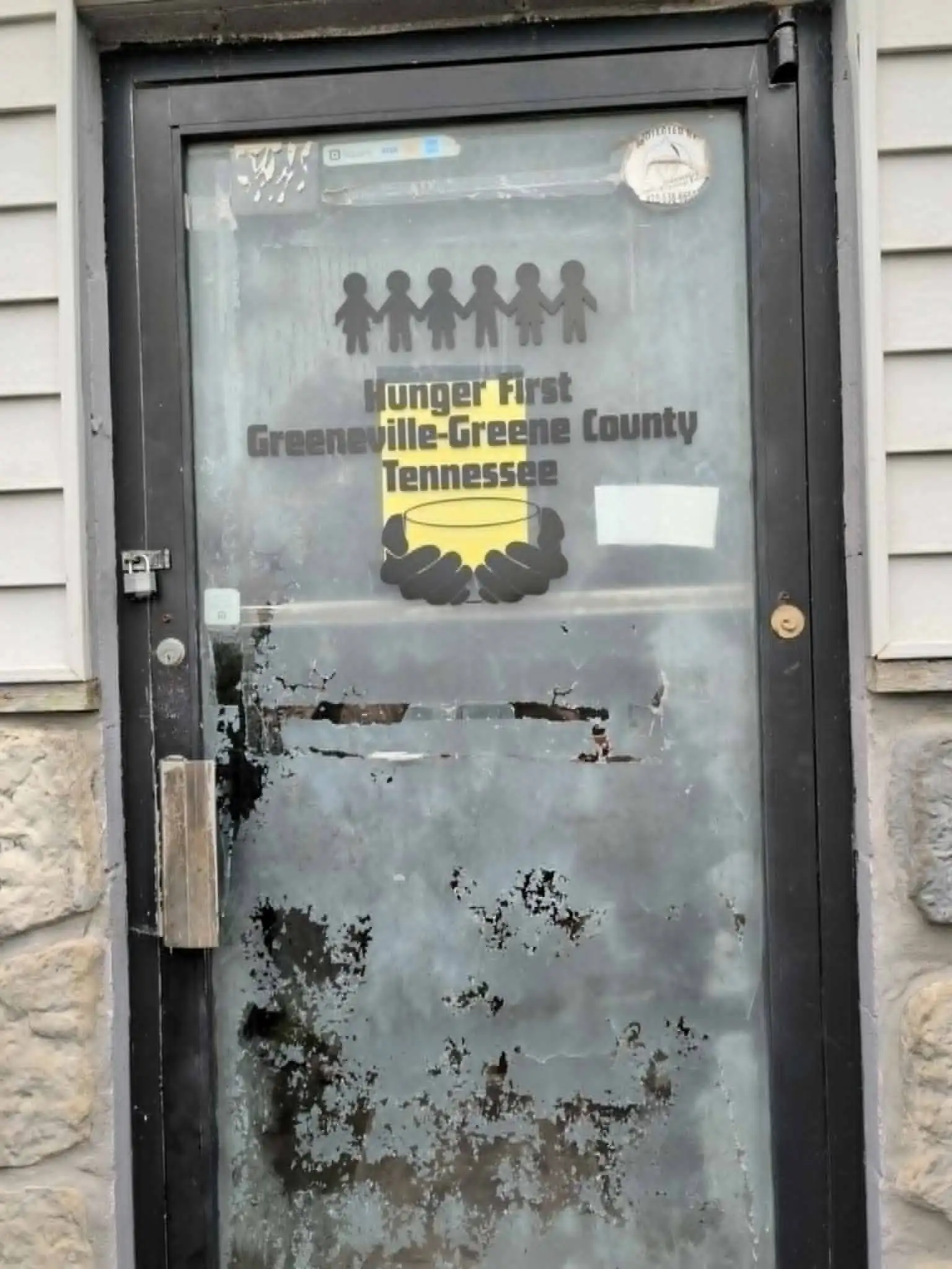 The front door at Hunger First Greeneville with the organization’s decal on the glass.